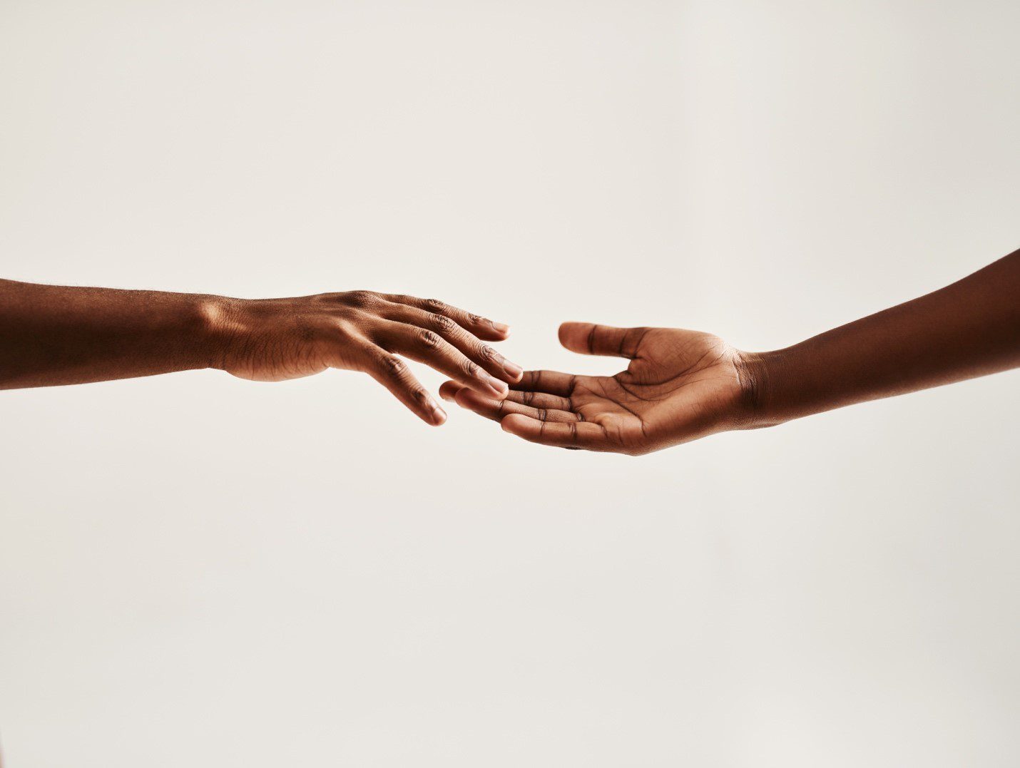 Two hands reaching out to each other.